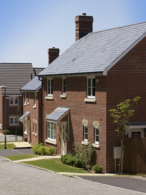 stock-photo-a-new-modern-housing-development-a-row-of-recently-built-new-houses-constructed-of-red-brick-with-55733704